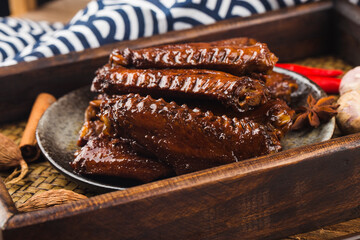 The duck's wings were boiled and placed on a  plate
