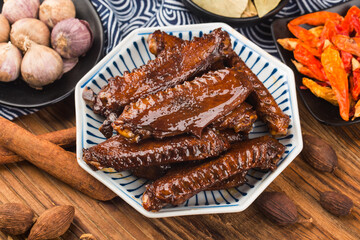 The duck's wings were boiled and placed on a  plate