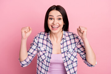 Photo of grateful young millennial lady hands fists wear plaid shirt isolated on pink color background