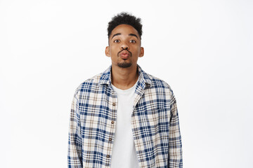 Romantic and cute african american guy pucker his lips, waiting for kiss, kissing someone, standing...