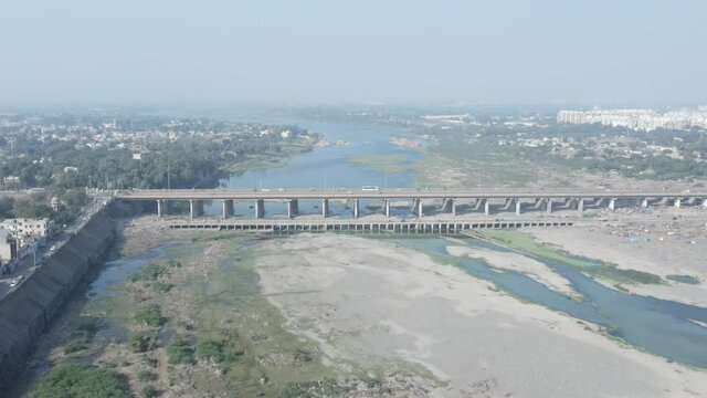 Cars driving onto Bridge towards City Skyline , Aerial birds eye view tilt up
