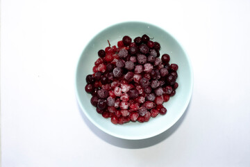 unfocused blue cup with frozen cranberries