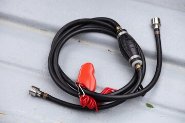 Fuel hose with manual pump and connectors for outboard motor with gas tank connection on the motor boat
