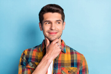 Portrait of attractive curious pensive cheerful guy touching chin making decision isolated over...