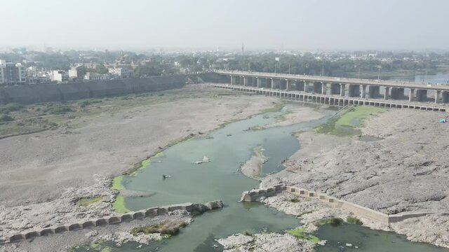 Cars driving onto Bridge towards City Skyline , Aerial birds eye view tilt up