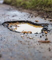 Pothole in the middle of a road. 