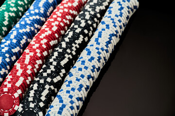 Stack of Casino gambling chips isolated on black reflective background