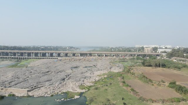 Cars driving onto Bridge towards City Skyline , Aerial birds eye view tilt up