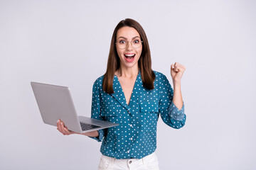 Portrait of attractive trendy cheerful girl holding using laptop having fun isolated over gray pastel color background