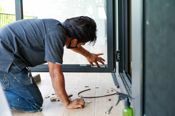 Selective focus on hands of workers repairing the door frame