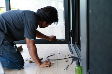 Selective focus on hands of workers repairing the door frame