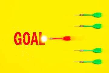 A red dart was rapidly rushing towards the target. which has 4 slower green darts. Concept about speed to reach business goals