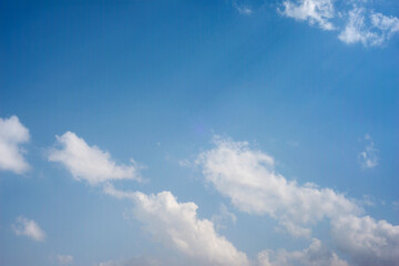 Scattered cloud clusters in a blue sky, blue sky background with white clouds,