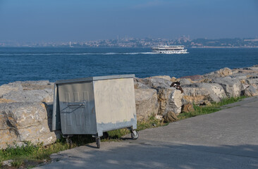 Fototapeta na wymiar metal garbage container by seaside, public park, street side, kadikoy, istanbul,