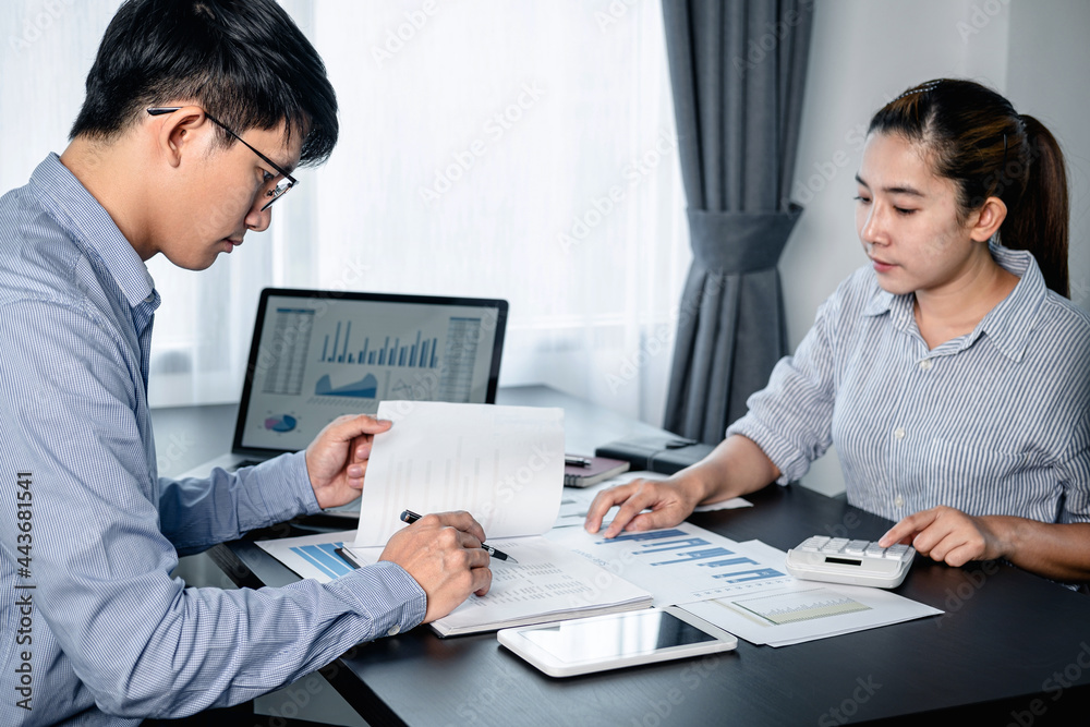 Aufkleber Two business colleagues using calculator to checking financial report with chart document and brainstorm