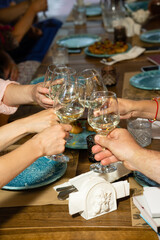 Glasses of champagne in the hands of friends in a restaurant