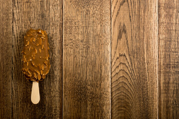 Chocolate Almond Popsicle Ice Cream Bar on Wood Background