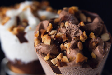 Two ice cream cones, one of cream and the other of chocolate