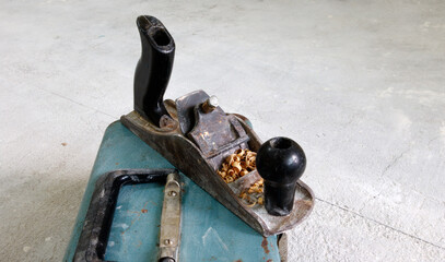 antique wood plane with sawdust
