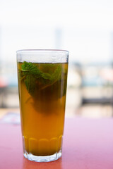 Vertical shot of a Glass of moroccan tea with mint plant with copy space