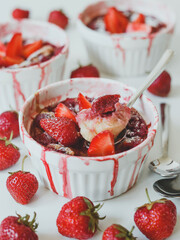 Homemade clafoutis with strawberries, a traditional summer French sweet fruit pie.