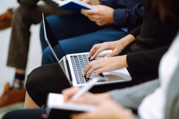 Group of business people meeting in a seminar conference. Audience listening to instructor and making notes. Student training, lecture. Planning, education, analysis, collaborate work in teamwork.