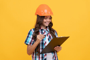 future engineer hold clipboard. safety work expertise. teen girl in protective hard hat