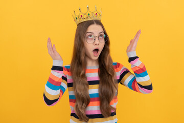 surprised egoistic kid in glasses wear queen crown on yellow background, surprise