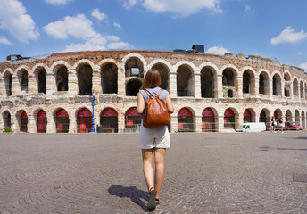 Tourism in Verona. Back view of tourist woman walks towards Verona Arena, Italy.