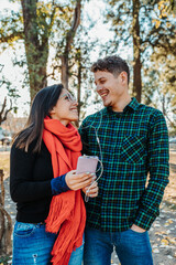 young couple listening to music outdoors