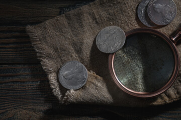 Numismatics. Old collectible coins made of silver on a wooden table.