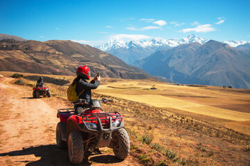 biker in the mountains taking pictures of a beautiful view © oscargutzo