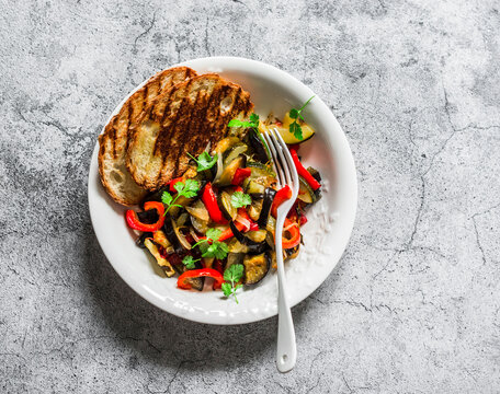 Roasted Ratatouille, Grilled Bread - Delicious Summer Season Vegetarian Appetizers, Lunch, Snack On A Grey Background, Top View