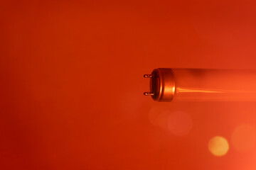 A fluorescent lamp in the frame with a red filter and a small side illumination. A lamp that emitted infrared light. Free space for text.