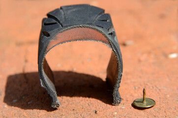 Cross section of bicycle tyre with Kevlar reinforcement, and a thumb tack as reference.