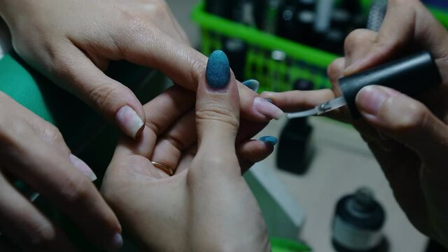 Manicure. Applying gel polish to the nails with the help of special manicure tools