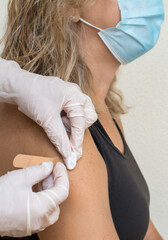 Close Up Shot Of Vaccine Procedure.
Woman Receives The Vaccination To Protect Against The Coronavirus.Covid-19 Vaccine.