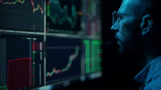 Trader is working with multiple computer screens with charts and data analysis and stock broker trading online. Concept of bitcoin and ethereum blockchain trading. Businessman is checking market data