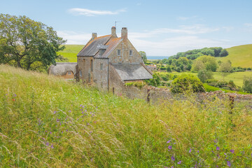 Traditional stone cottage farmhouse in the quaint countryside of the charming rural English village...