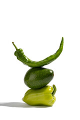 Fresh green vegetables and on gray background. Food balance of pepper and avocado