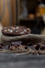 Chocolate cookies with hazelnuts , cocoa and pieces of dark chocolate on the rustic kitchen table