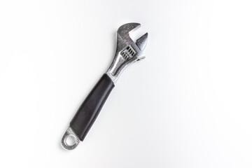 A wrench on a white background. A horn key with a black handle. Space for the text. Free space next to the image of the adjustable wrench.