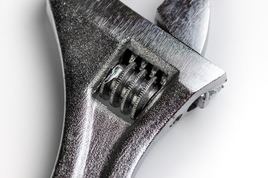 Adjustable wrench screw on a white background close-up. A free space next to the image of the screw for reducing the jaws of the adjustable wrench.