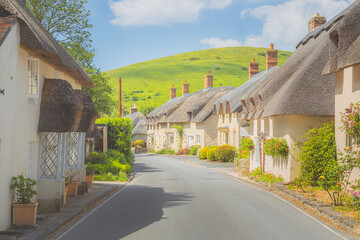 Quaint, picturesque countryside thatched roof cottages in the scenic English village of West...