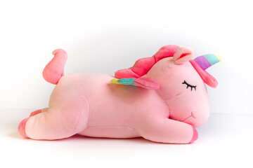 Unicorn on a white background. A soft unicorn toy. A stuffed unicorn. A mythical character. © Grigorii