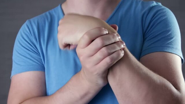 Guy has wrist injury or inflammation of chronic arthritis. Health care and medical concept.