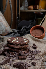 Chocolate cookies with hazelnuts , cocoa and pieces of dark chocolate on the rustic kitchen table