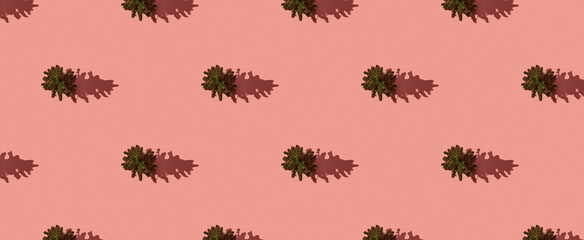 Pattern of christmas trees on pink pastel background