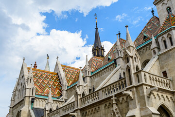 Fototapeta na wymiar Details of the Matthias Church (Mátyás Templom) that is a Roman Catholic church located in Budapest, Hungary, in front of the Fisherman's Bastion at the heart of Buda's Castle District, in a sunny day