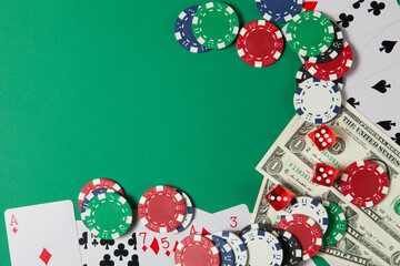 Classic playing cards, chips, red dice and dollars on green background. Gambling and casino concept. - obrazy, fototapety, plakaty
